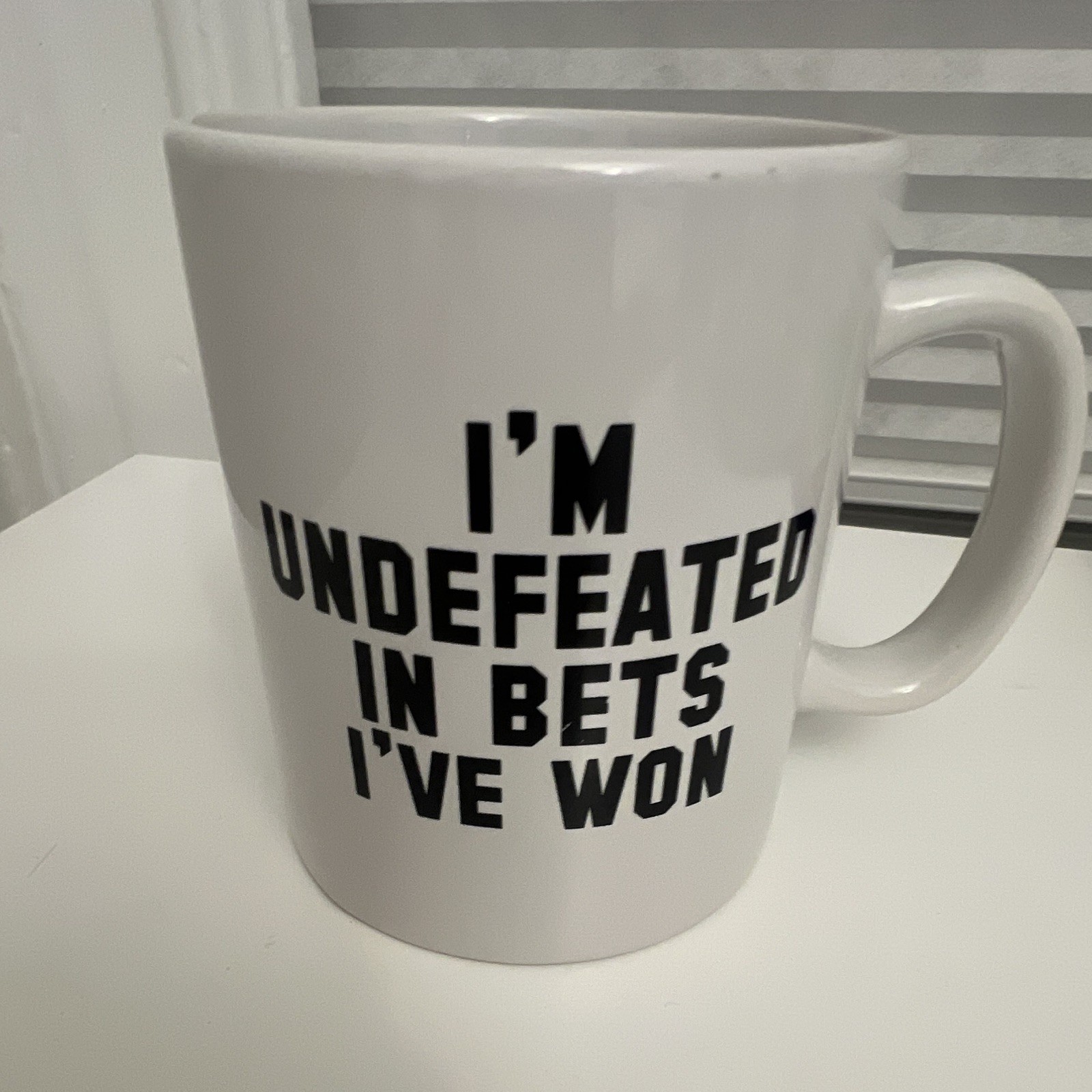 Barstool Sports “I’m Undefeated In Bets I’ve Won” 13 fl oz White Ceramic Mug