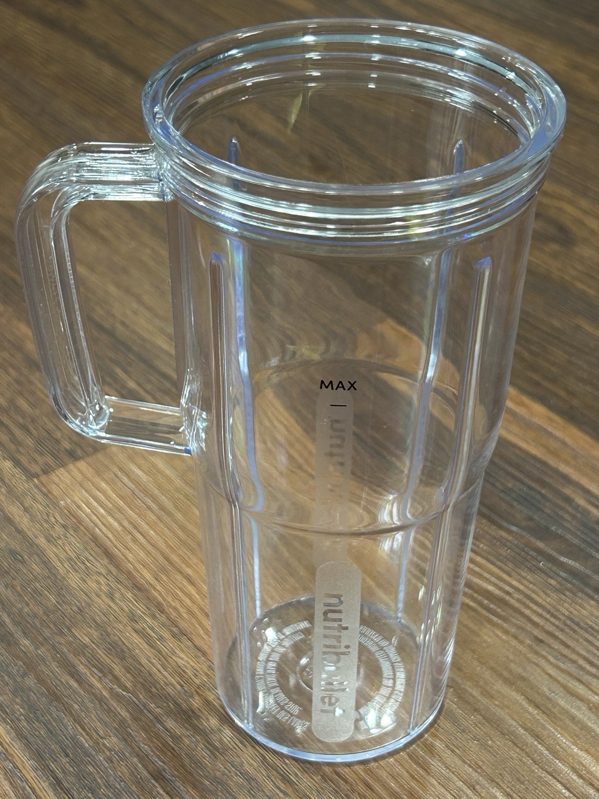 NutriBullet 24 oz Travel Cup with a handled design and black to-go lid New