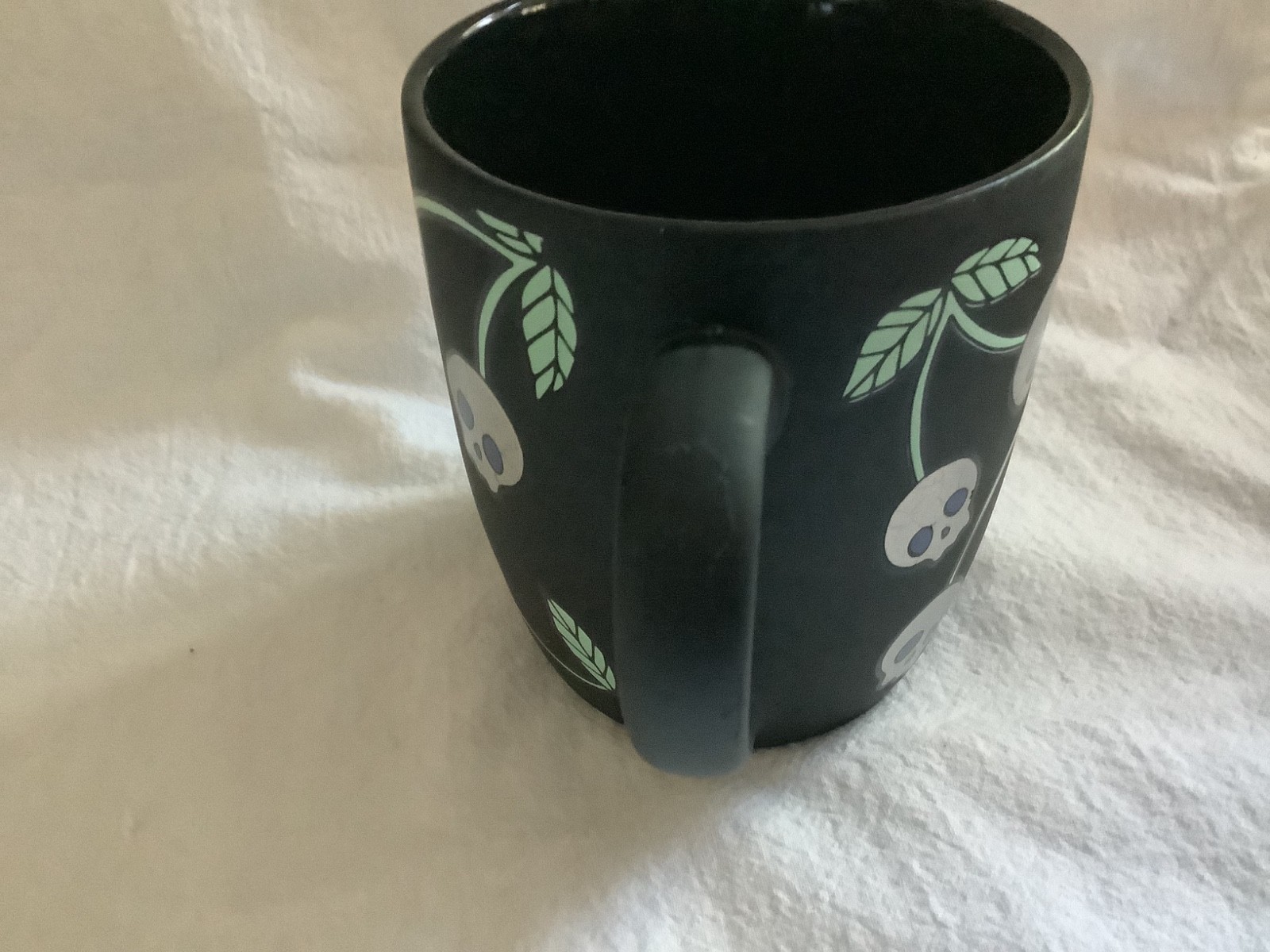 Cobwebs and Cauldrons skulls coffee mug black 16 oz.