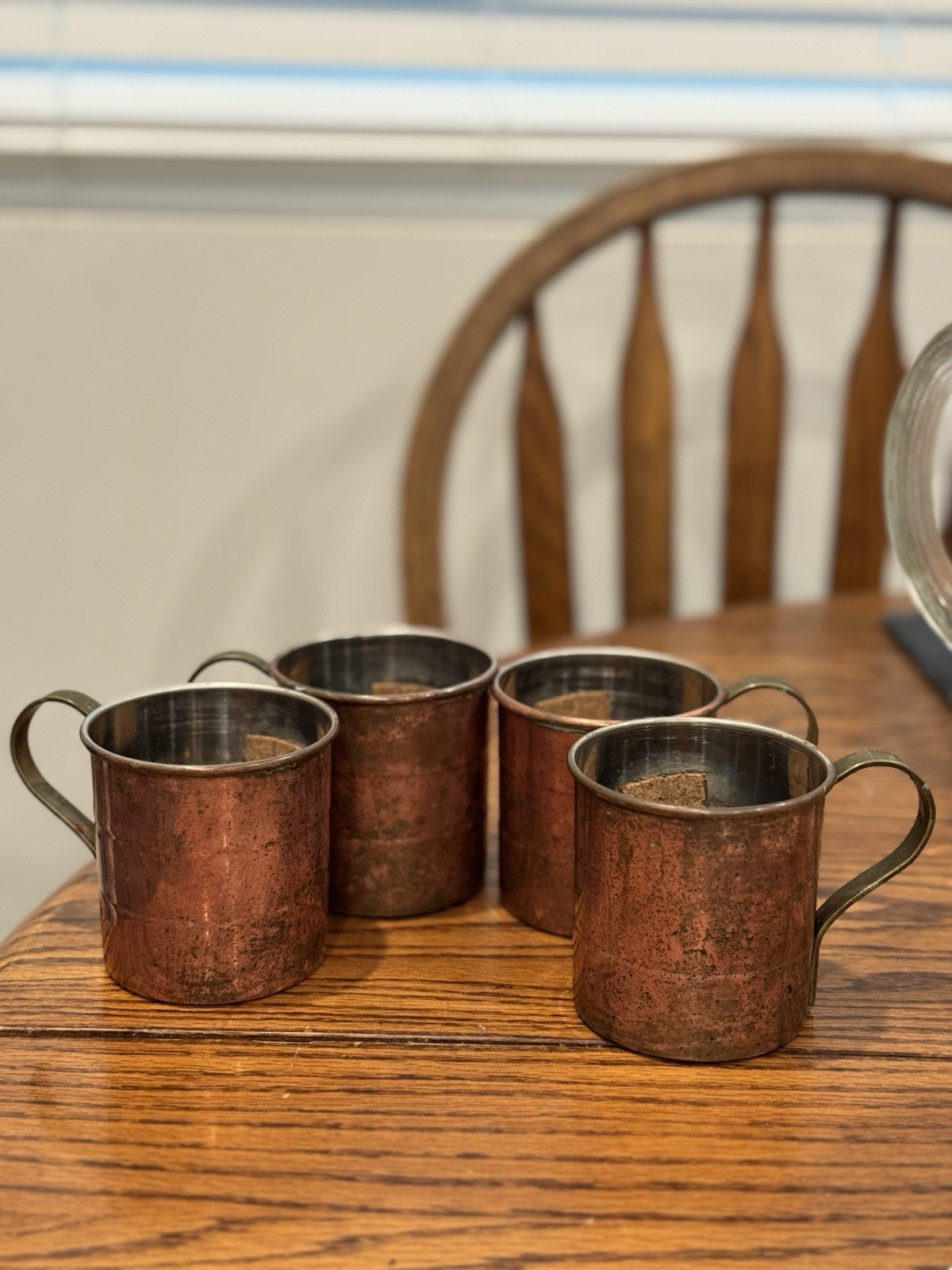 Set of four vintage copper Moscow Mule mugs with stainless steel handles