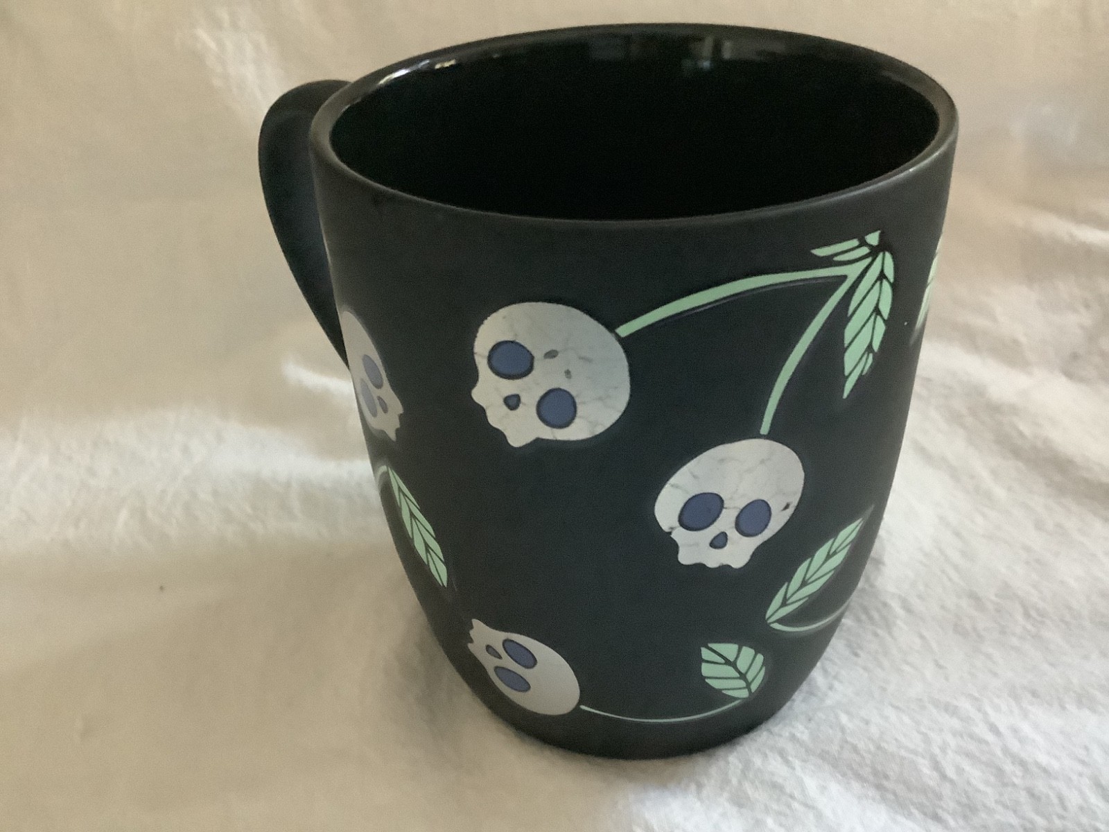 Cobwebs and Cauldrons skulls coffee mug black 16 oz.